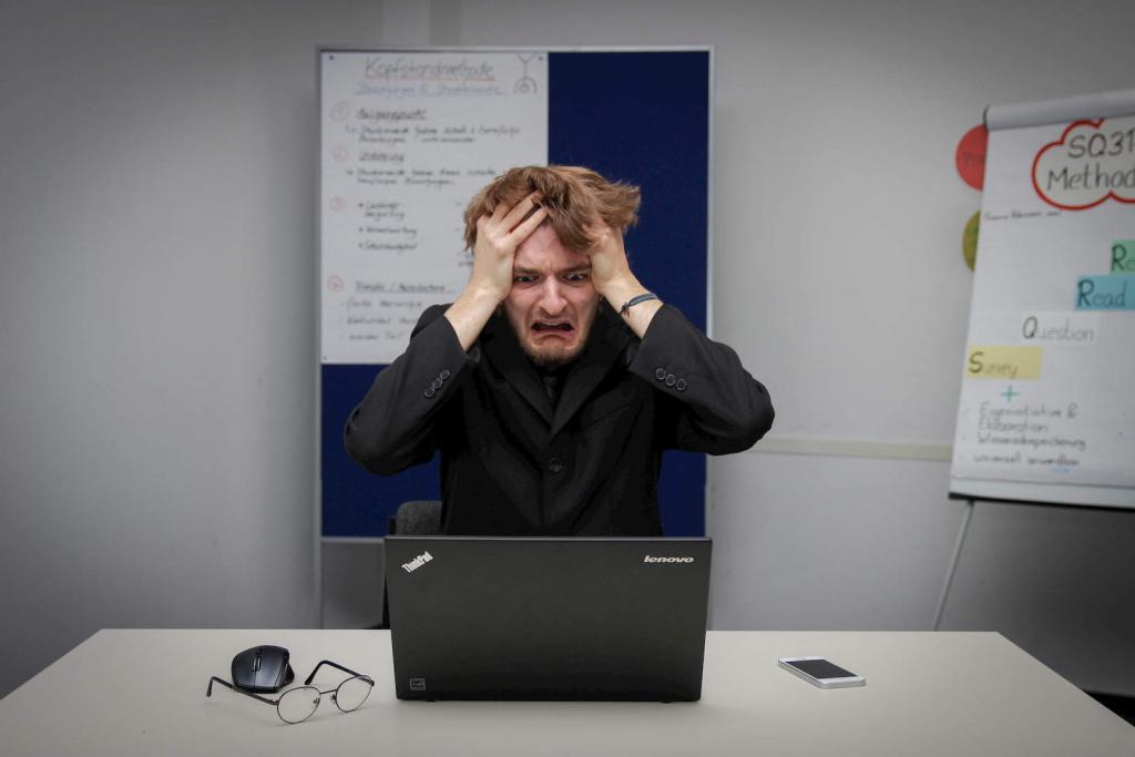 Man pulling hair out due to burnout and stress