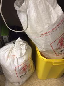 Image of large whit bags containing paper prescriptions