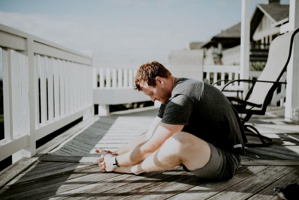 Man doing yoga outside on wooden balcony, exercise is a good way to reduce blood pressure, e-surgery