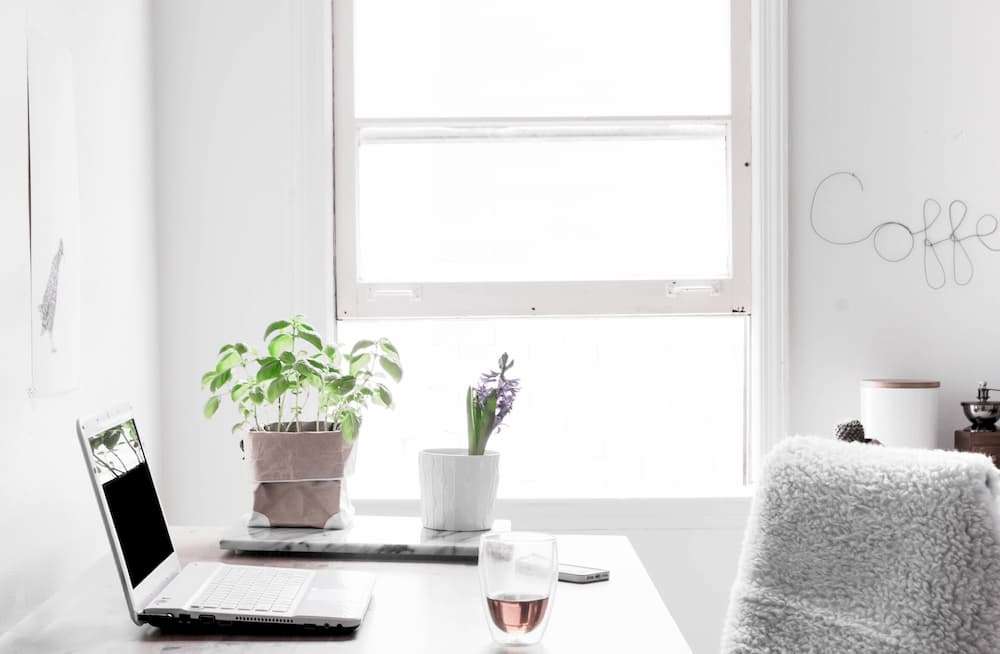 Desk against window and laptop on table, vitamin D can help with Acne, e-Surgery