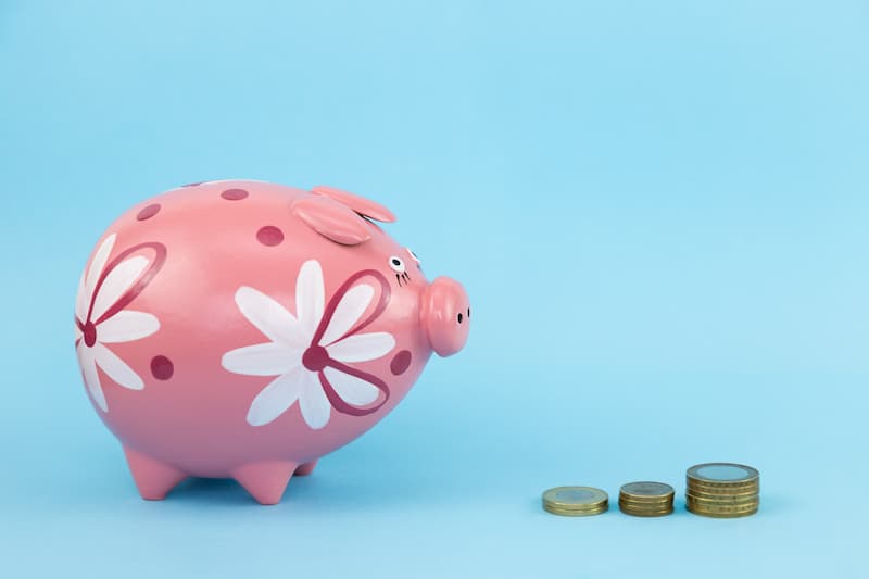 Pink piggy bank with coins, kindness in lockdown, e-Surgery