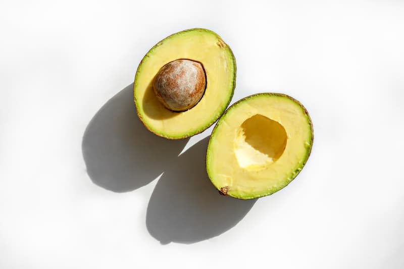 Avocado cut in half with stone in the middle, find alternatives healthy fats to reduce cholesterol, e-Surgery