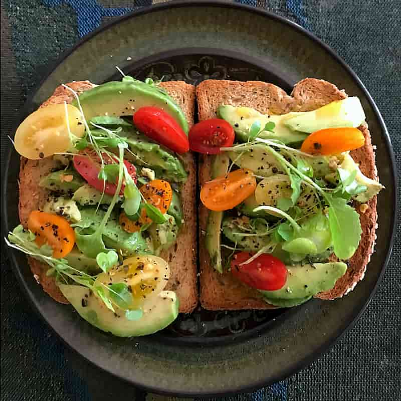 Avocado and tomato on toast on a rustic plate | The Orlistat Diet: Avoid These Foods! | e-Surgery 