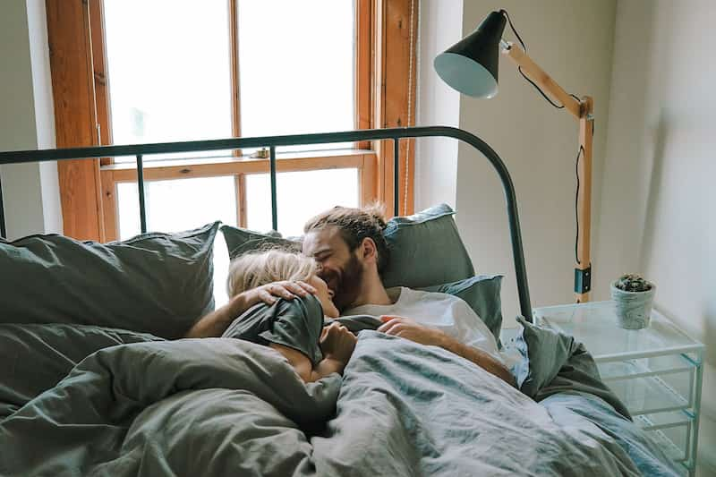 Young couple cuddling in bed, does Lovegra really work? e-Surgery