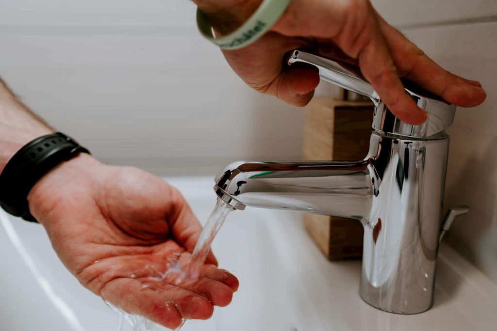 Frequent hand washing and hand sanitiser use can prevent infection, image of person washing hands with warm water