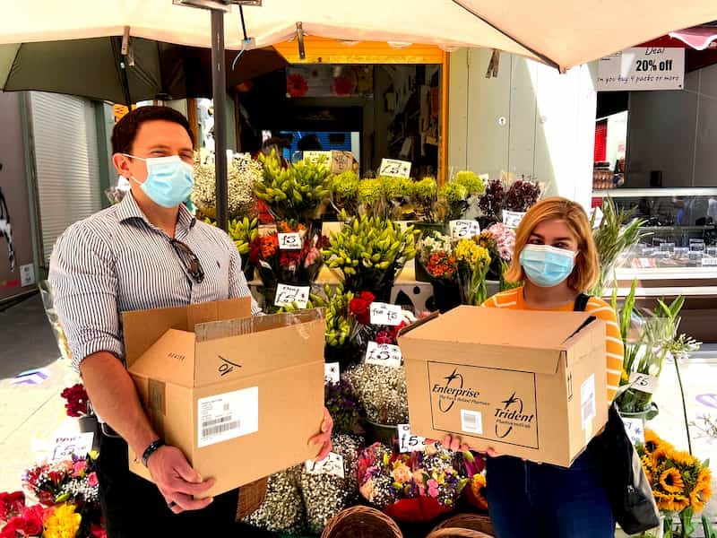 e-Surgery CEO's handing out hand sanitiser for free in Norwich Market, Flower shop in Norwich market