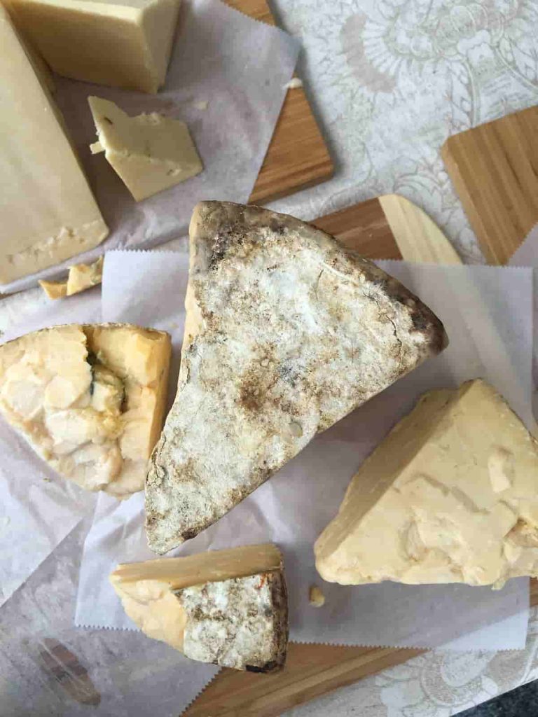 Aged cheese on wooden chopping boards and wax paper | Does Your Diet Trigger Migraines? | e-Surgery 