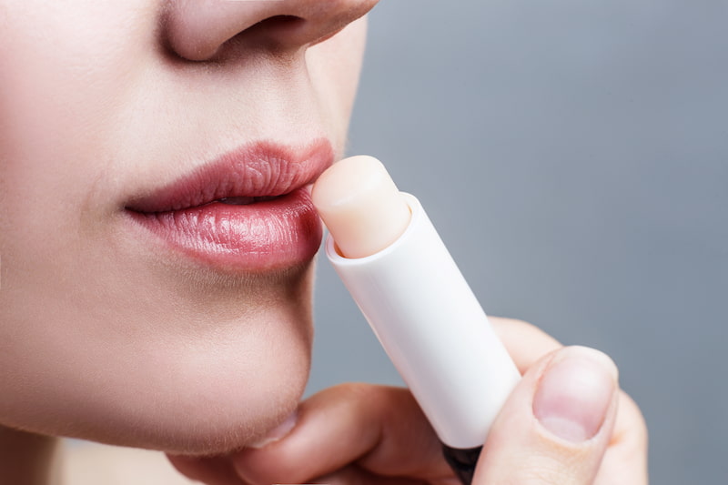 lady applying lip balm