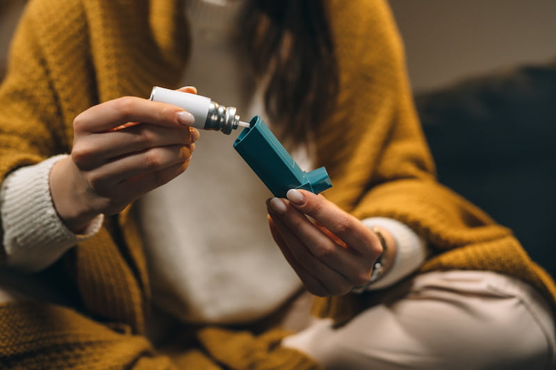 Woman filling Inhaler for winter illness