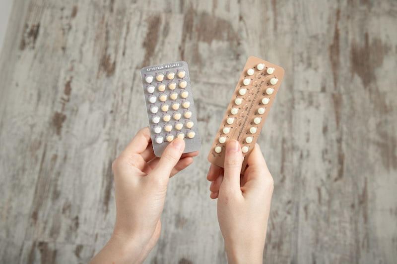 Woman choosing between two morning after pills