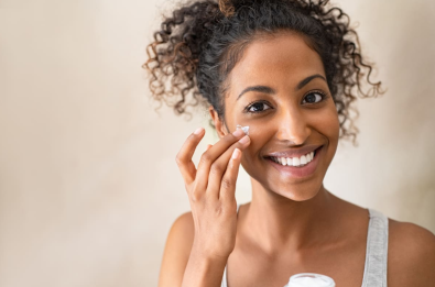 woman applying face cream as acne treatment | eSurgery