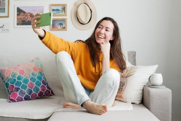 Woman holding phone on sofa