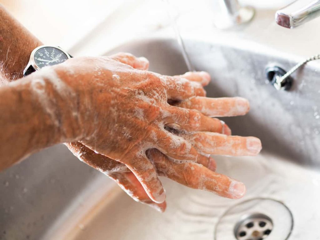 Man washing hands with soap and water