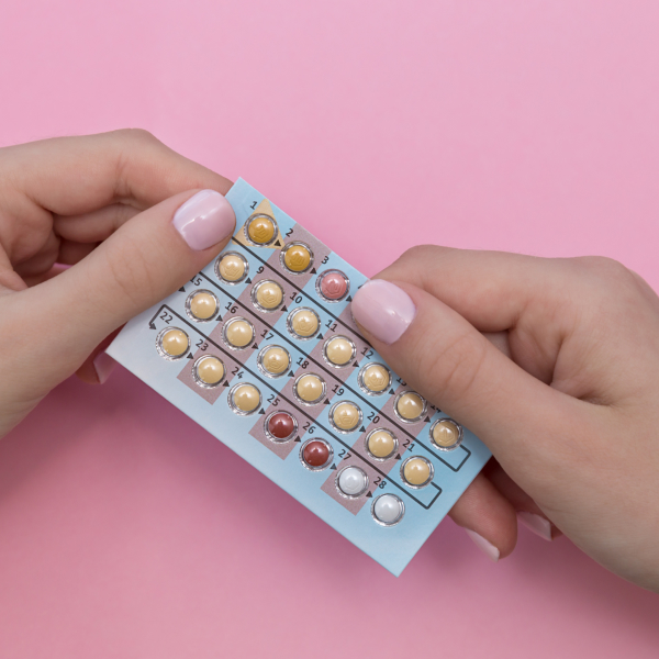 Woman using contraception for PMS relief from period pain